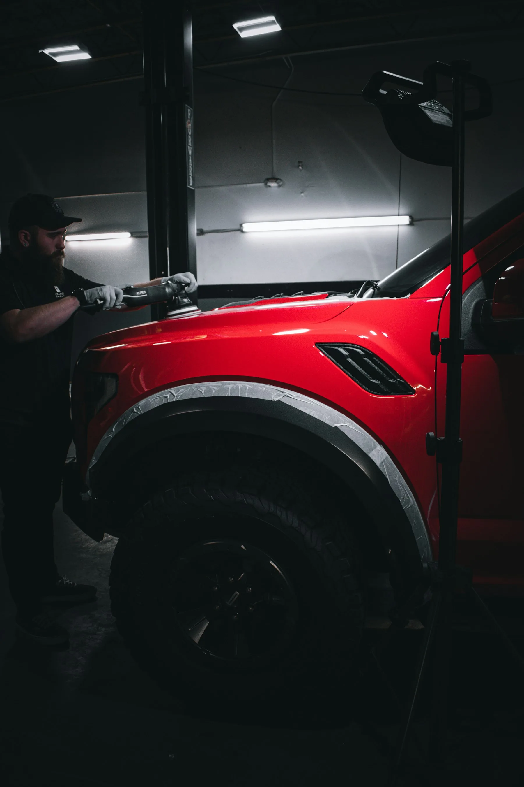 Detailer carefully polishing a car's painted finish